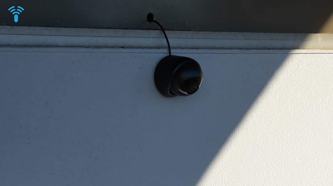 Outdoor installation of the UniFi Protect G6 Turret camera under the building eaves