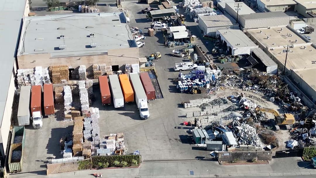 Drone view of the main recycling company headquarters spanning multiple detached buildings.