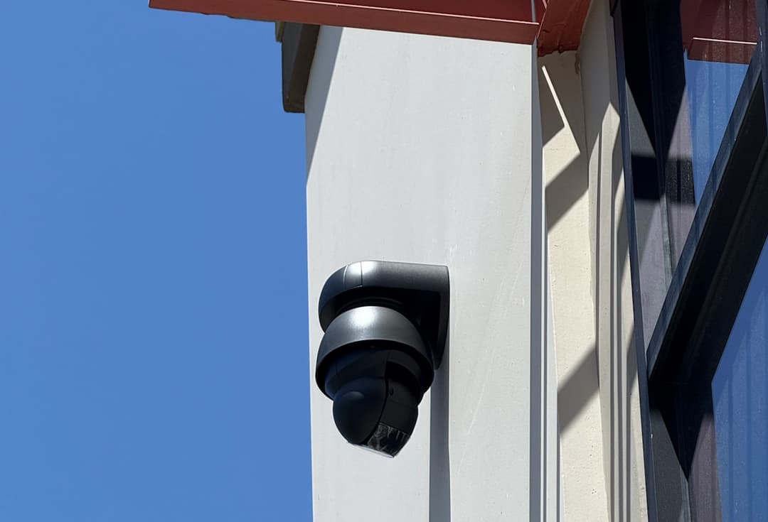 Ubiquiti G4 PTZ Industrial Camera mounted on warehouse wall for AI-enhanced perimeter security by YesTechie