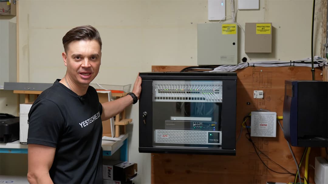 YesTechie engineer presenting the fully upgraded MDF network rack with clean cable management.