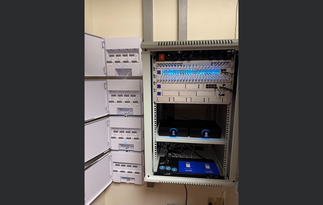 Professional installation of high-power commercial audio amplifiers in a clean enterprise server rack with organized structured cabling.