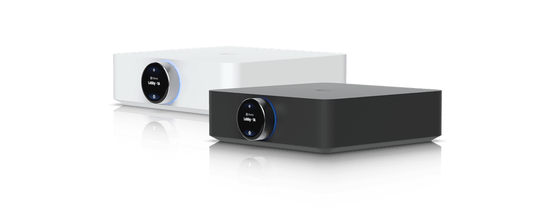 Sleek black and white commercial audio amplifiers featuring interactive touchscreen controls for multi-zone sound distribution.