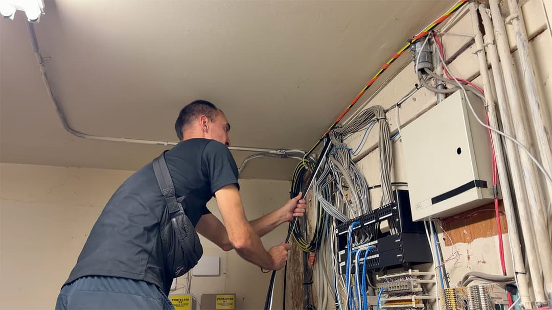 Engineer preparing the server room wall for a new managed network switch installation.