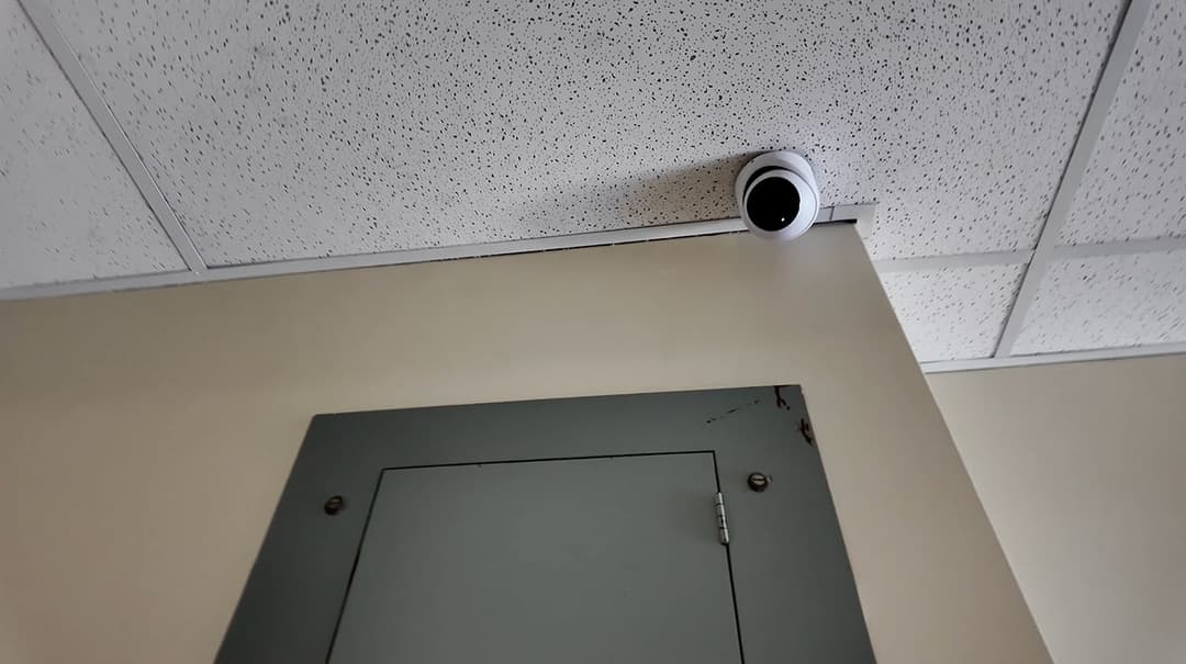 Corner mounted UniFi G6 Turret security camera looking down the corridor