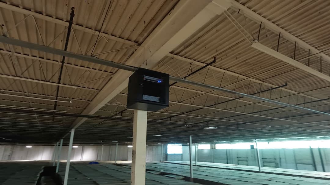 Wall-mounted Intermediate Distribution Frame IDF enclosure inside the warehouse