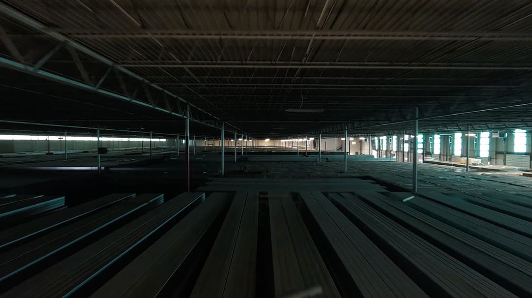 Symmetrical view down a warehouse aisle with deployed Wi-Fi 7 infrastructure