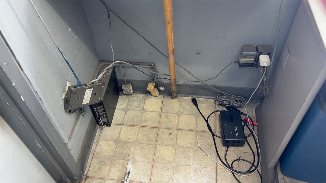 Unmanaged switch on the floor creating a tripping hazard and potential network failure.