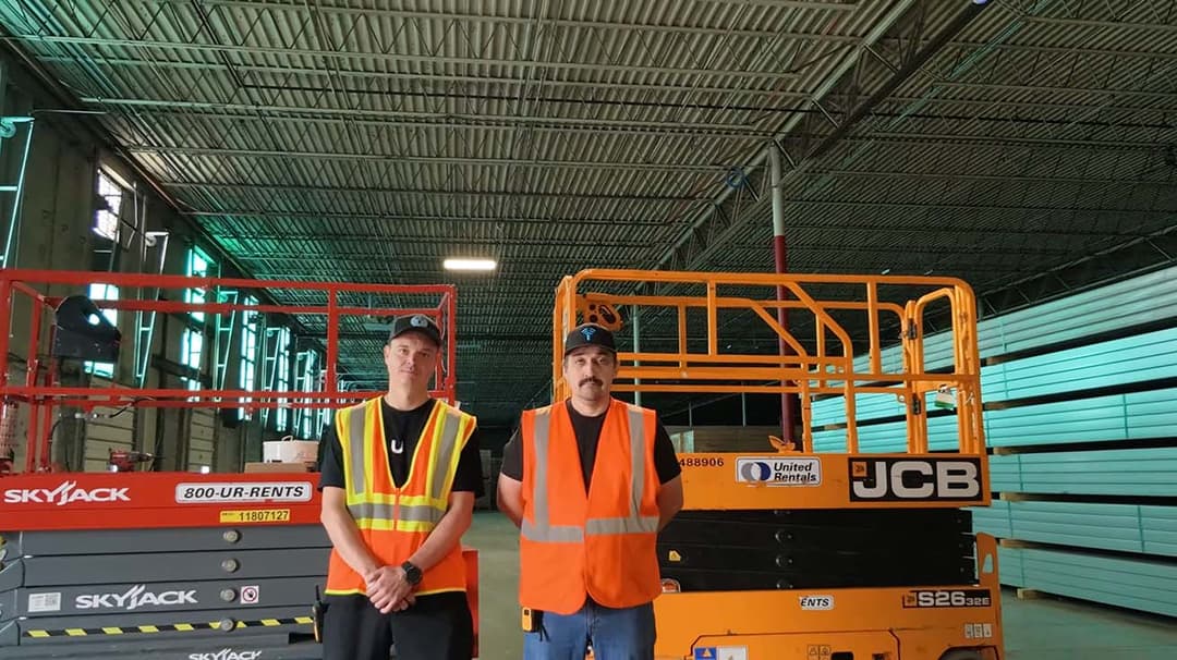 YesTechie field team preparing equipment next to an industrial scissor lift